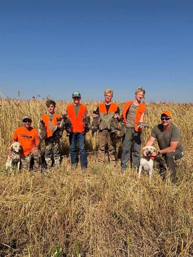 Group of hunters and bird dogs after a full-day event at Rapid Rooster